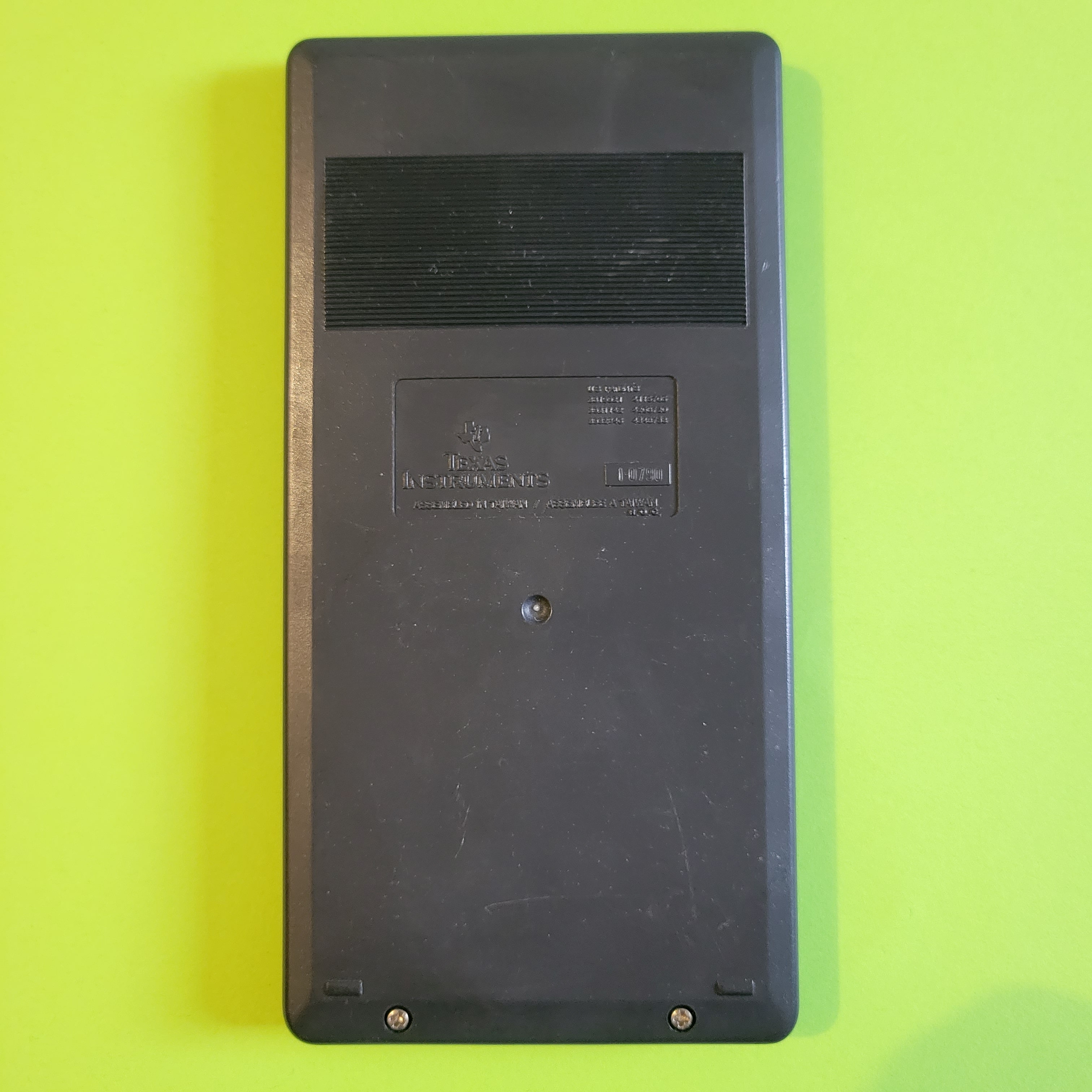 An image of the back of a texas instruments ti-34 scientific/engineering calculator